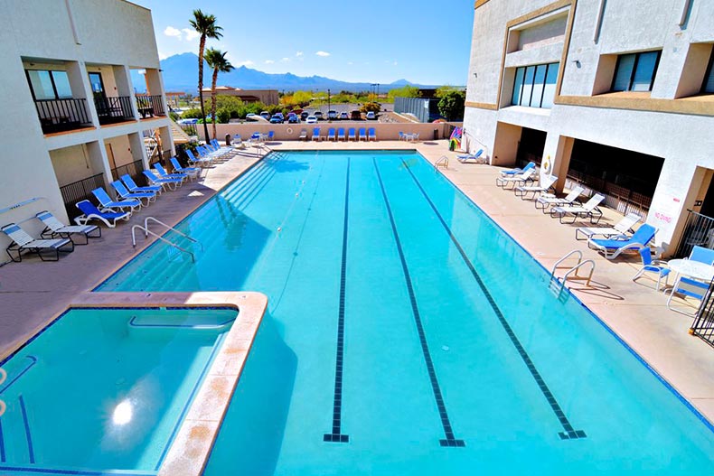Lounge chairs surrounding the outdoor pool at Desert Hills 3 West in Green Valley, Arizona