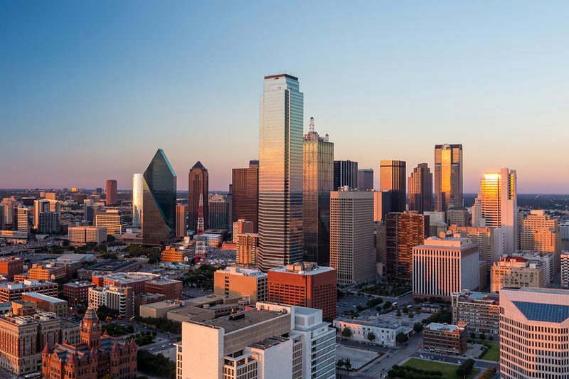 Dallas, Texas cityscape with blue sky at sunset.