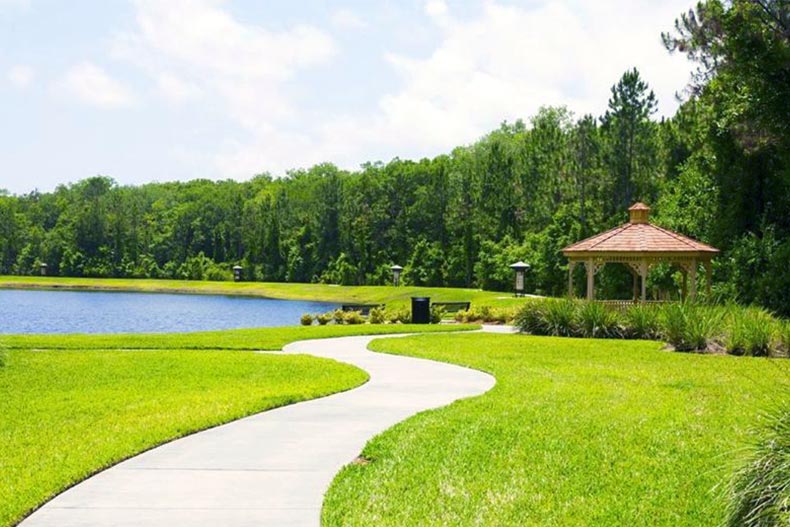 Photo of a pathway with a lake, gazebo, and forest area in Del Webb Ponte Vedra in Ponte Vedra, Florida