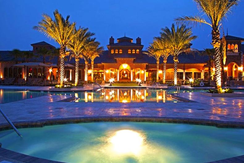 Exterior photo of the Anastasia Club at Del Webb Ponte Vedra at night from the perspective of the spa and resort-style pool