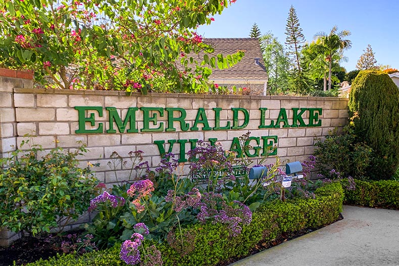 Greenery surrounding the community sign for Emerald Lake Village in Oceanside, California