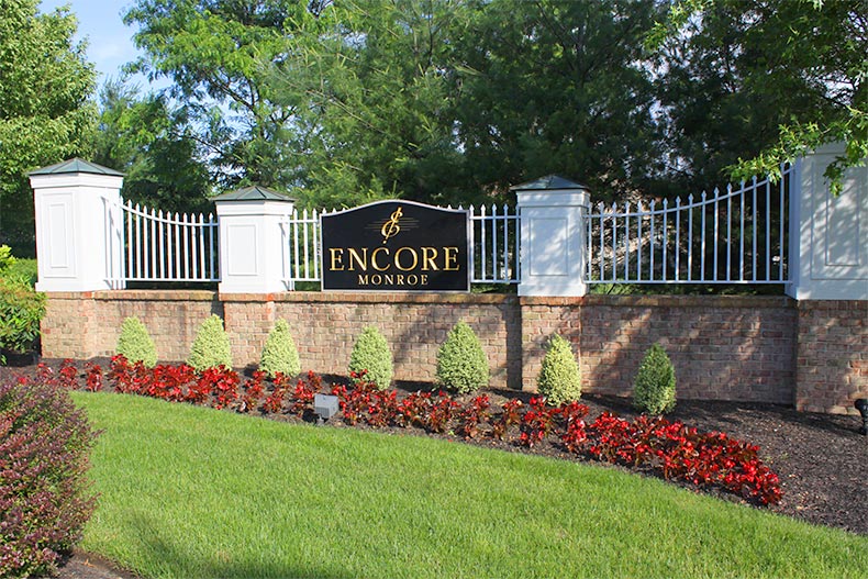 The community sign mounted on a fence surrounding Encore Monroe in Monroe, New Jersey