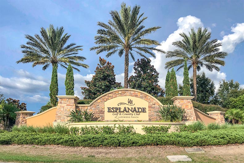 Palm trees behind the community sign for Esplanade at Lakewood Ranch in Lakewood Ranch, Florida