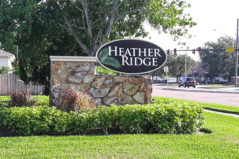 Grass and shrubs surrounding the community sign for Heather Ridge in Dunedin, Florida