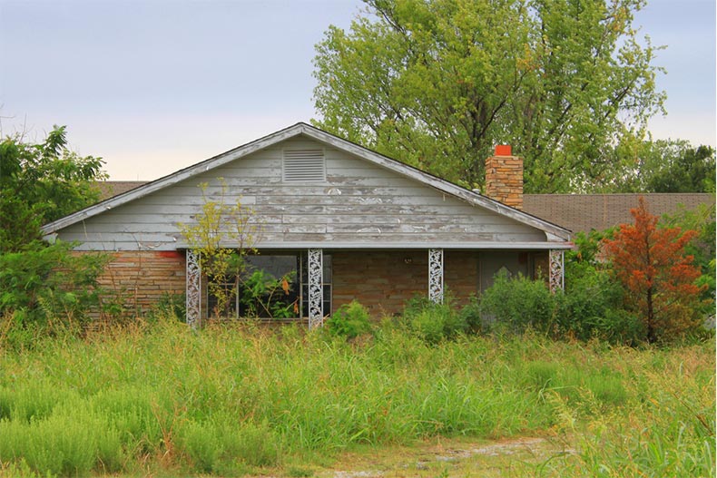 An old house overgrown with grass