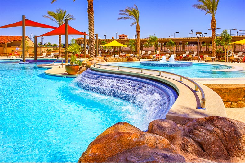 Resort-style pool with waterfall and shade in Sun City Festival, Arizona