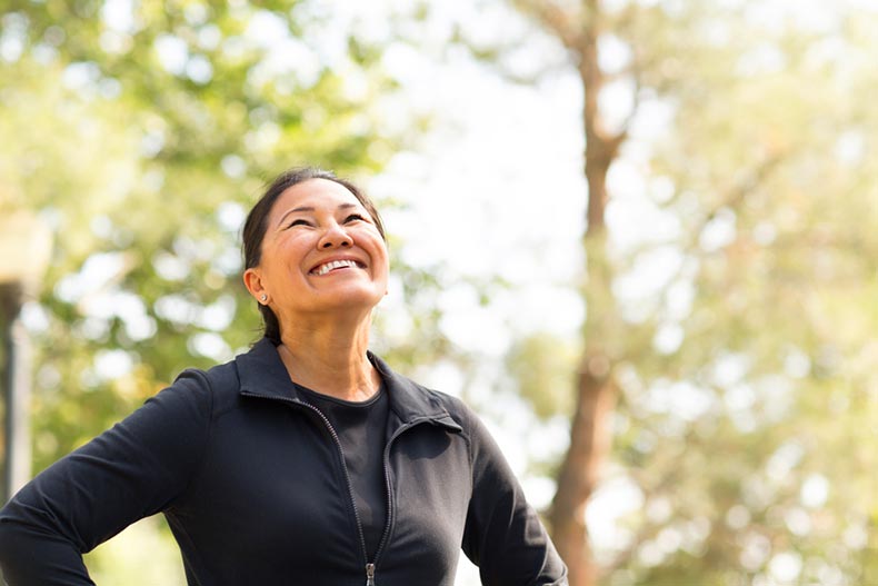 A fit woman exercising and walking outside in her 55+ community