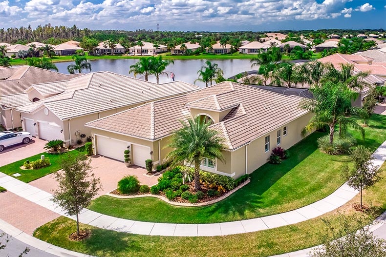 Aerial view of homes surrounding a pond at Valencia Lakes in Wimauma, Florida
