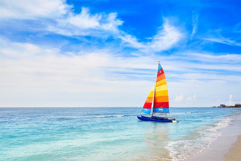 A catamaran sailboat on a shoreline of a beach in Fort Myers, Florida