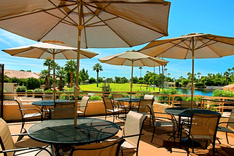 Several patio tables under umbrellas located in Fountain of the Sun in Mesa, Arizona