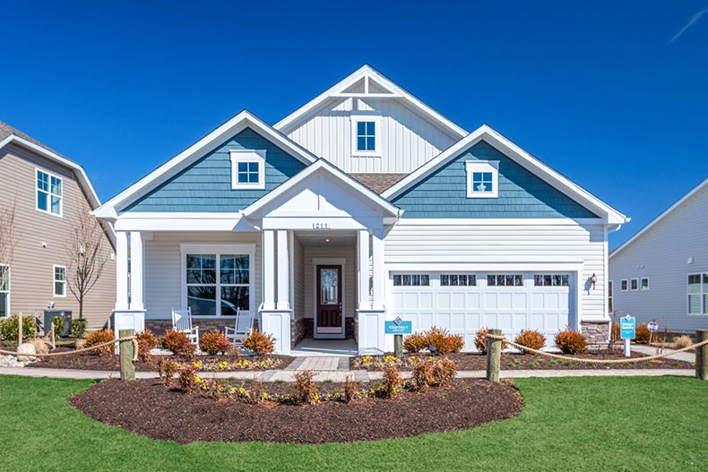 Exterior view of a blue model home at Four Seasons at Carolina Oaks in Bluffton, South Carolina