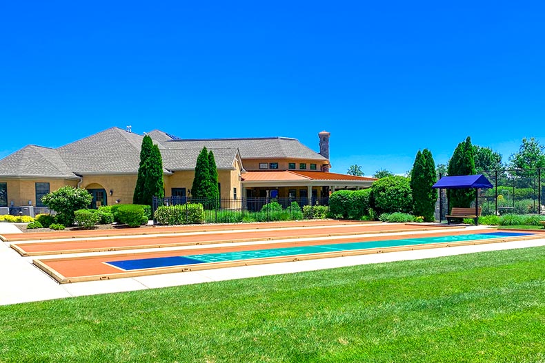 Photo of shuffleboard courts in front of a clubhouse at Foxfield in Garnet Valley, Pennsylvania