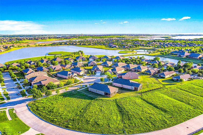 Aerial view of homes near a pond at Frisco Lakes in Frisco, Texas