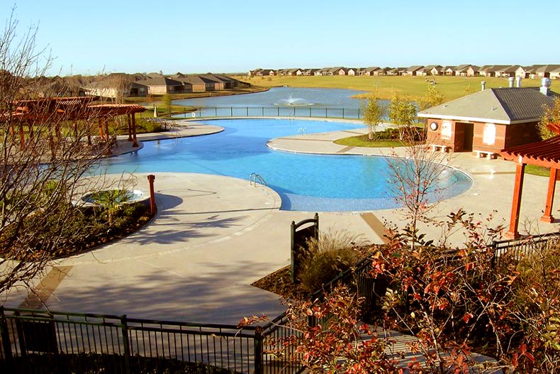 Overhead photo of a resort-style pool in Frisco Lakes, Frisco, Texas with homes in the background