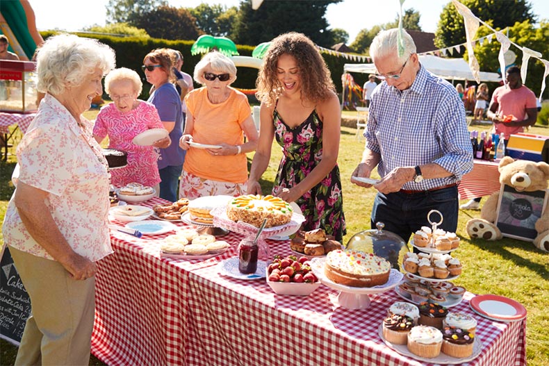 People are a bake stand at a small public festival