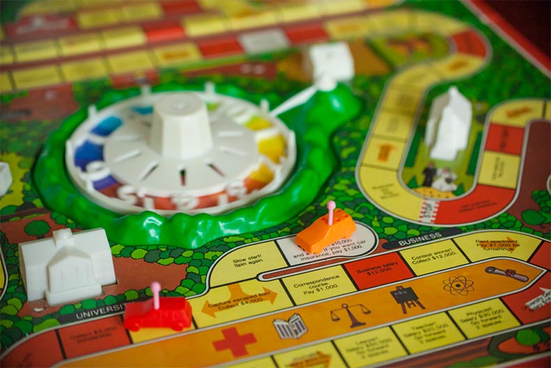 Close up of a spinner and board for The Game of Life