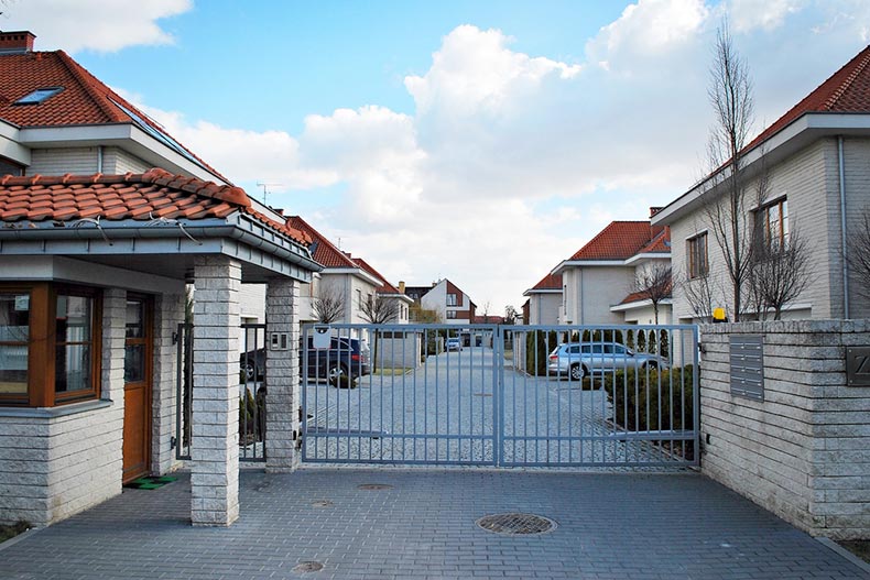 A gated entrance to a detached condo community