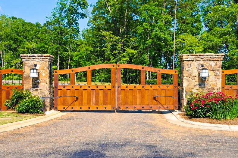 Closed gates that head into a residential community