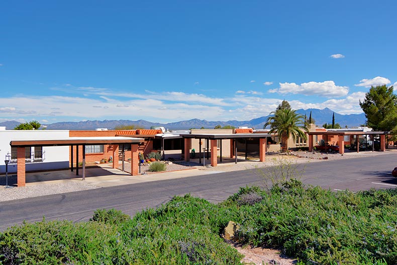 A roadway lined with residences and mountains in the background in Green Valley, Arizona