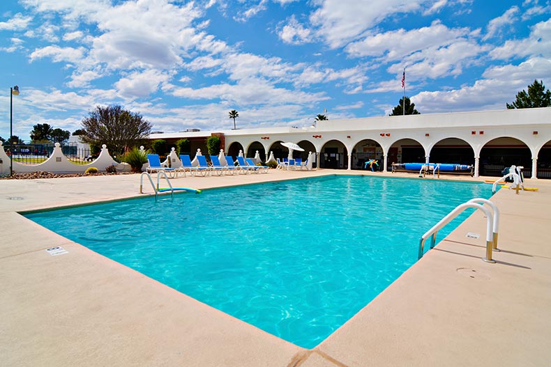 Lounge chairs beside an outdoor pool at Green Valley Recreation in Arizona