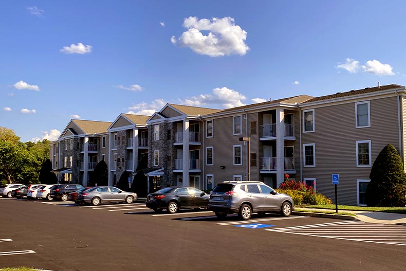 Exterior view of a condo building in The Greens at Westover with a parking lot in front, located in Norristown, Pennsylvania