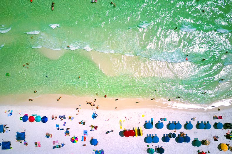 Aerial view of a beach dotted with beachgoers in Santa Rosa Beach, Florida