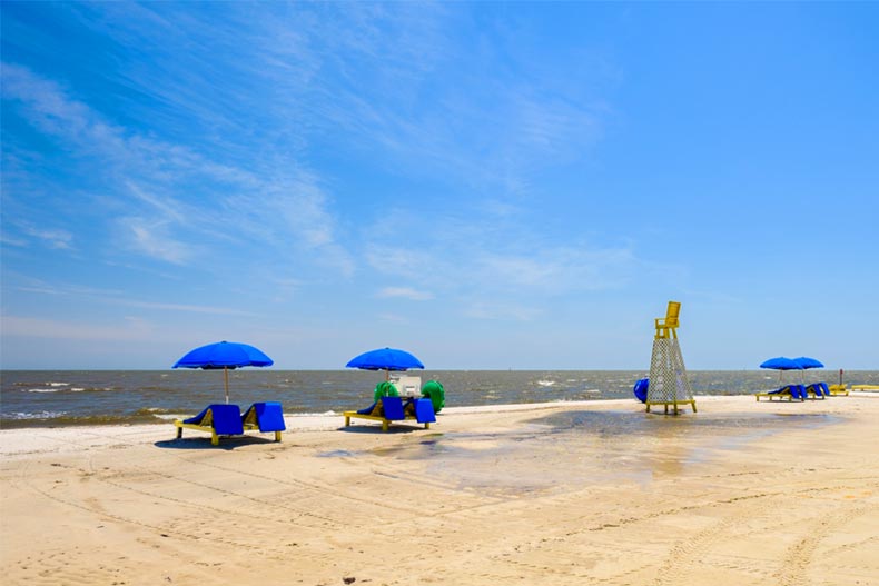 Gulf coast beach in Gulfport, Mississippi with lounge chairs along the shoreline