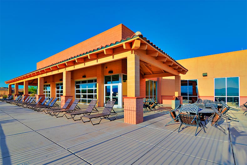 Lounge chairs and clubhouse on a patio in in Green Valley, AZ
