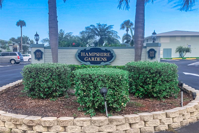Bushes in front of the community sign for Hampshire Gardens in Boynton Beach, Florida