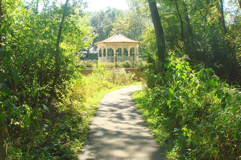 A tree-lined trail leading to a gazebo at Haverford Place in Hoffman Estates, Illinois