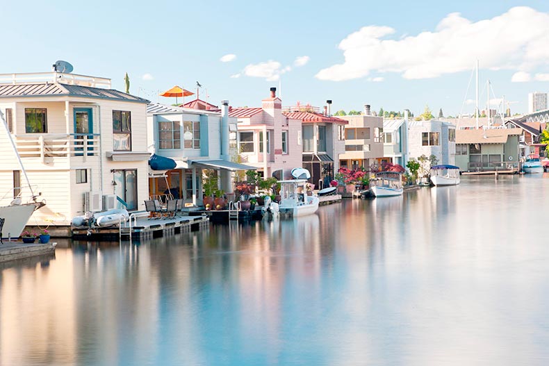 A row of colorful houseboats on the water