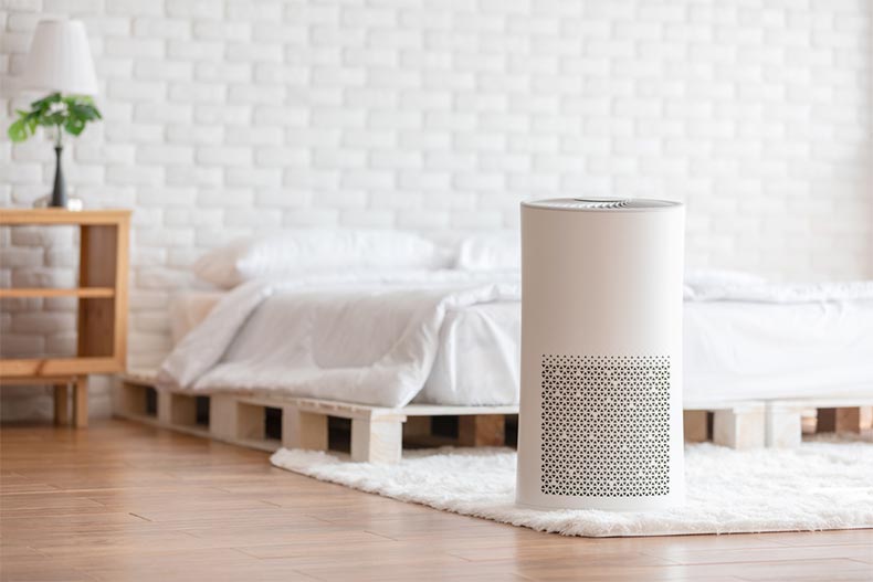 An air purifier filtering the air in a clean bedroom