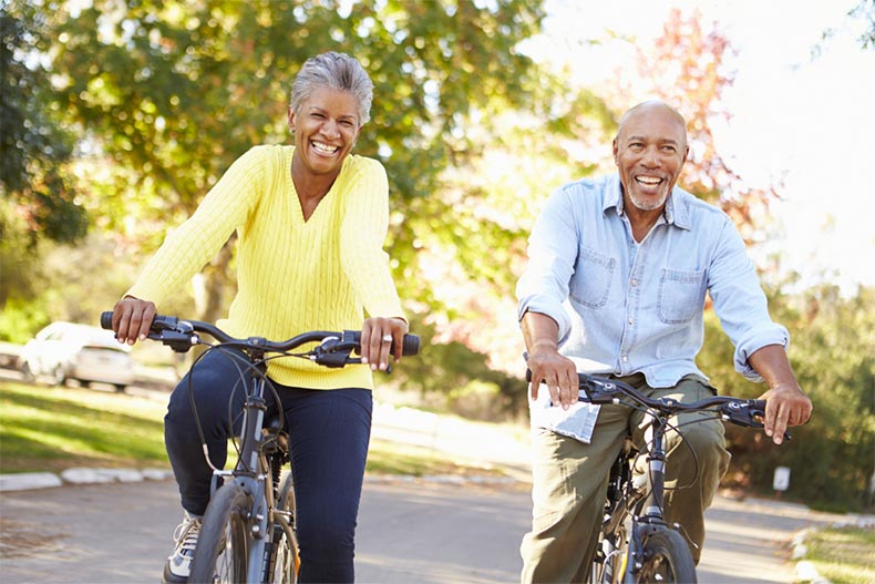 A senior couple on a bike ride on a sunny day