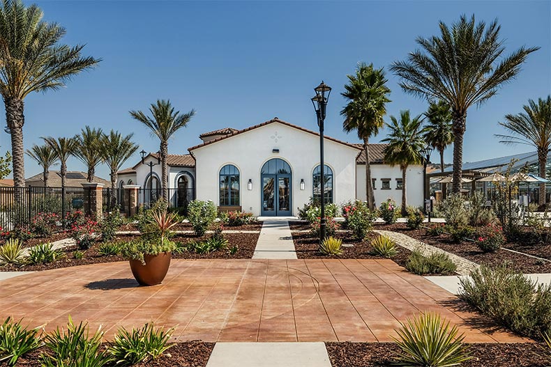 Exterior view of a community building surrounded by palm trees at Heritage El Dorado Hills in El Dorado Hills, California