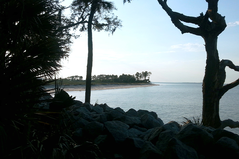 View from a rocky shore of a distant beach near Hilton Head Plantation of Hilton Head Island, South Carolina