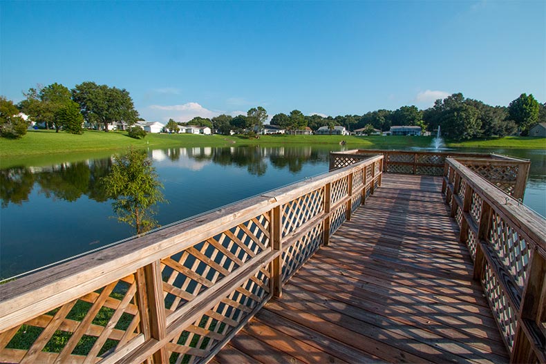 A wooden dock extending into a pond at Highland Fairways in Lakeland, Florida