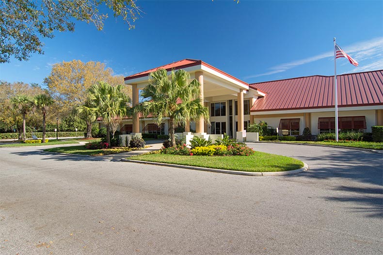 Exterior view of the clubhouse entrance at Highland Lakes in Leesburg, Florida