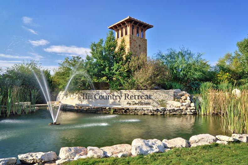 A water feature in front of the community sign for Hill Country Retreat in San Antonio, Texas