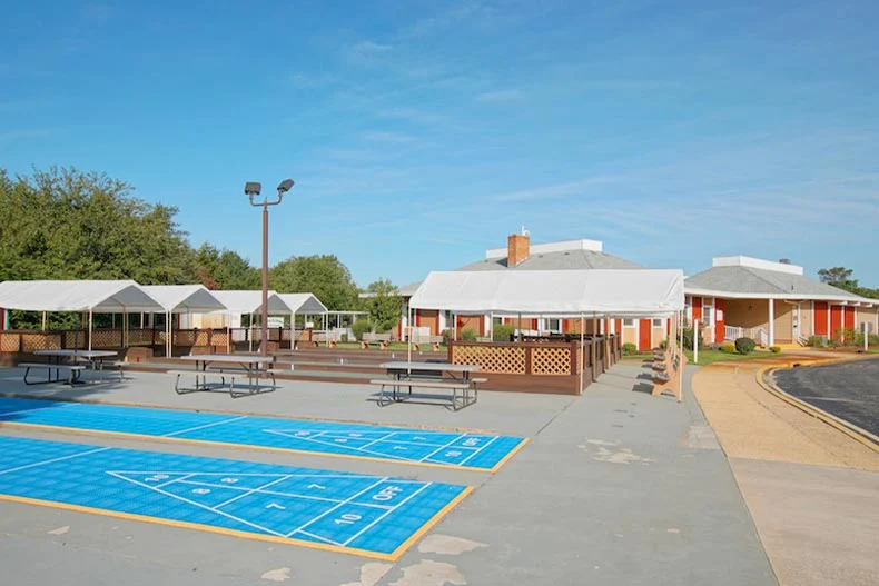 Exterior photo of clubhouses and bocce ball courts in the Holiday City at Berkeley 55+ community in Tom's River New Jersey