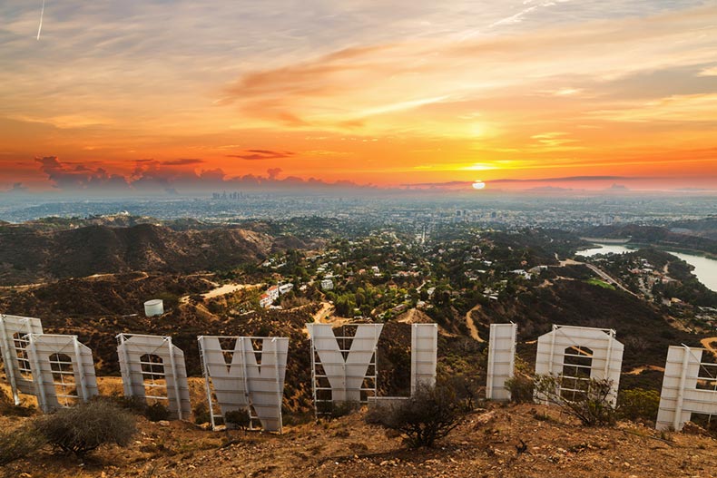 Rear view of the Hollywood sign and Los Angeles, California at sunset
