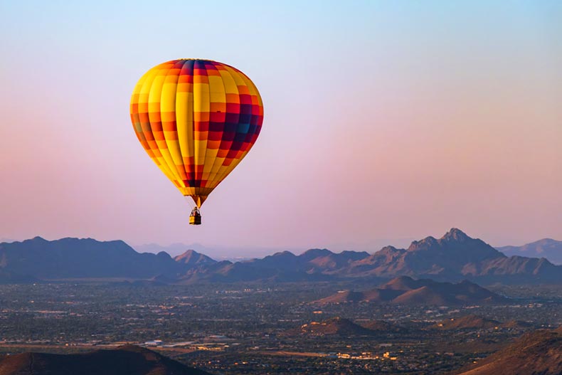 A lonely hot air balloon over Phoenix, Arizona with the Sonoran Desert in the background