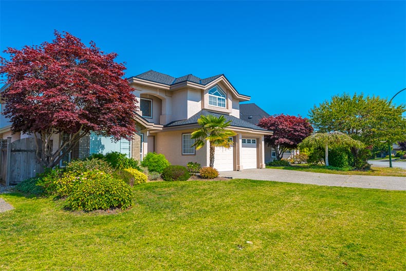 A modern single-family home with well-manicured landscaping