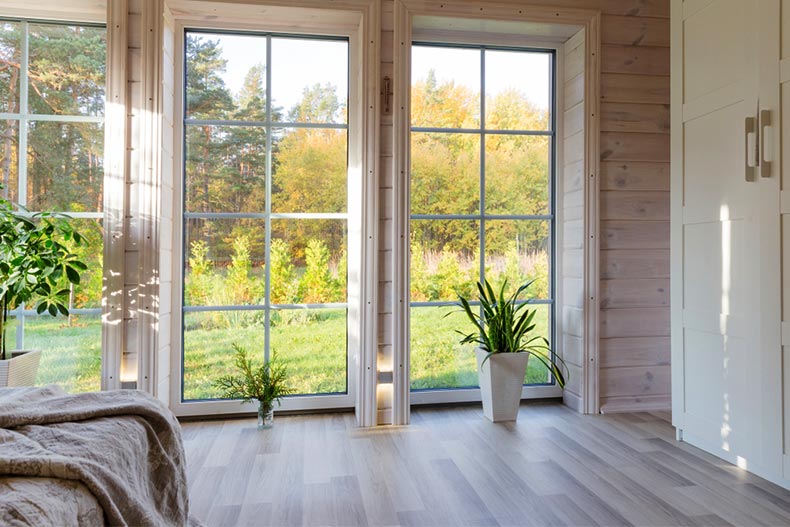 A bright room in a wooden house with a large window