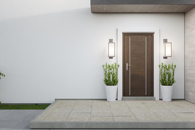 A new house with a wooden door and an empty white wall