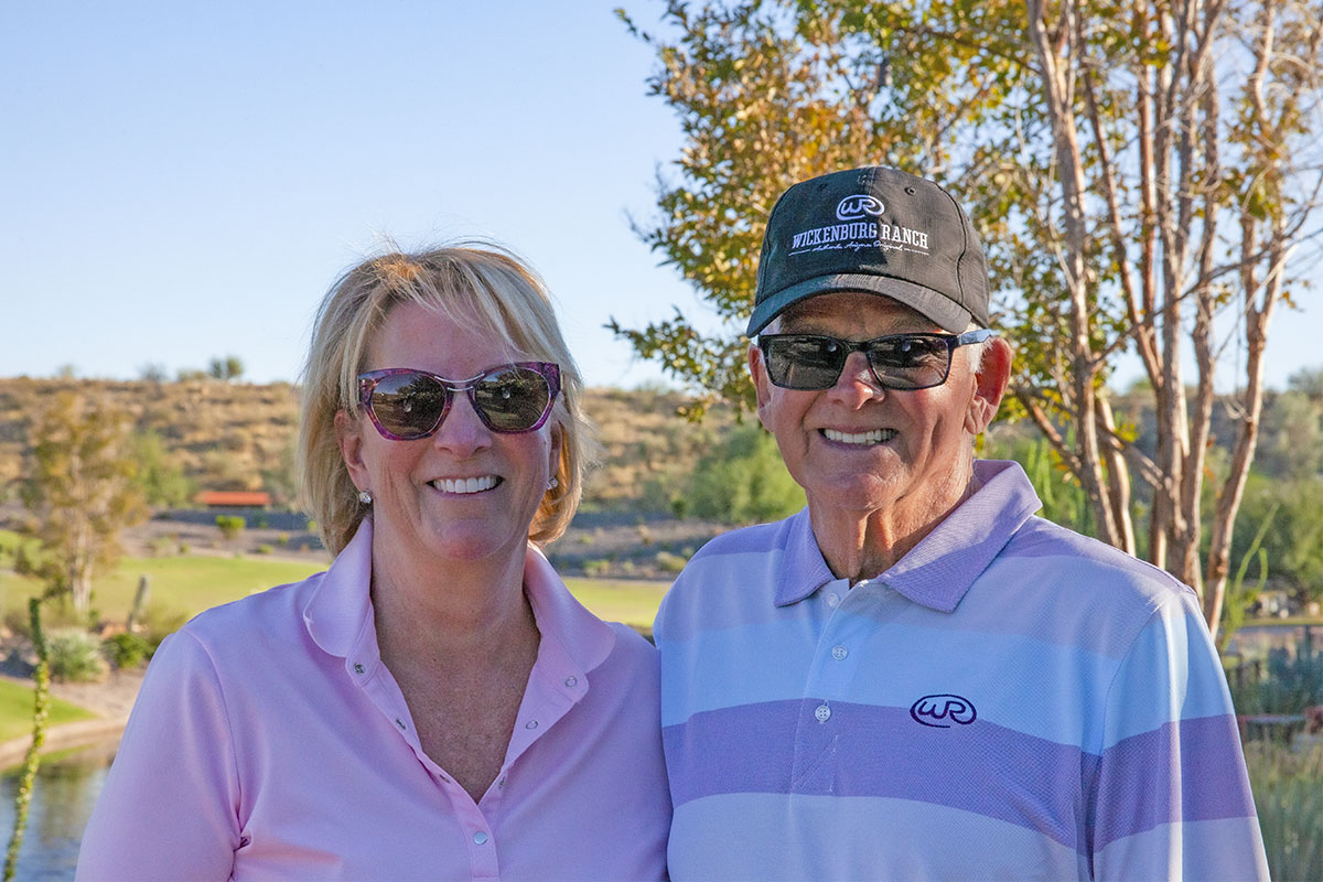 A smiling active adult couple who live at Trilogy at Wickenburg Ranch in Wickenburg, Arizona