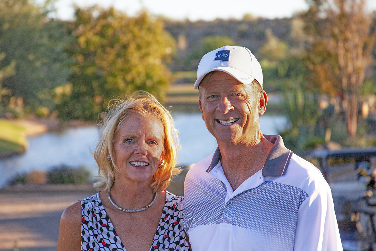 A smiling active adult couple who live at Trilogy at Wickenburg Ranch in Wickenburg, Arizona