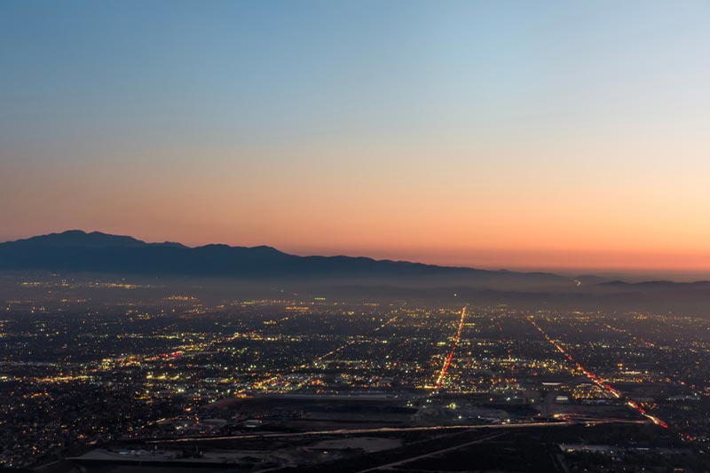 The city lights of the skyline of the Inland Empire near Los Angeles, CA at dusk.