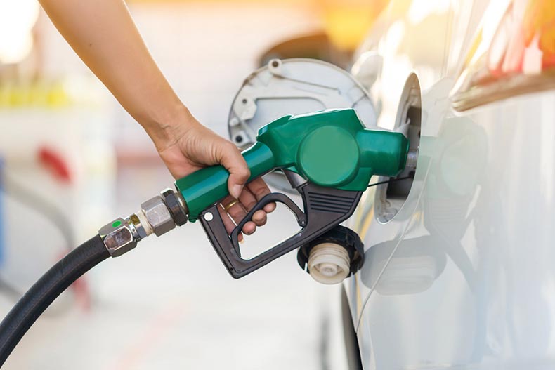 Closeup of a hand putting gas in a car