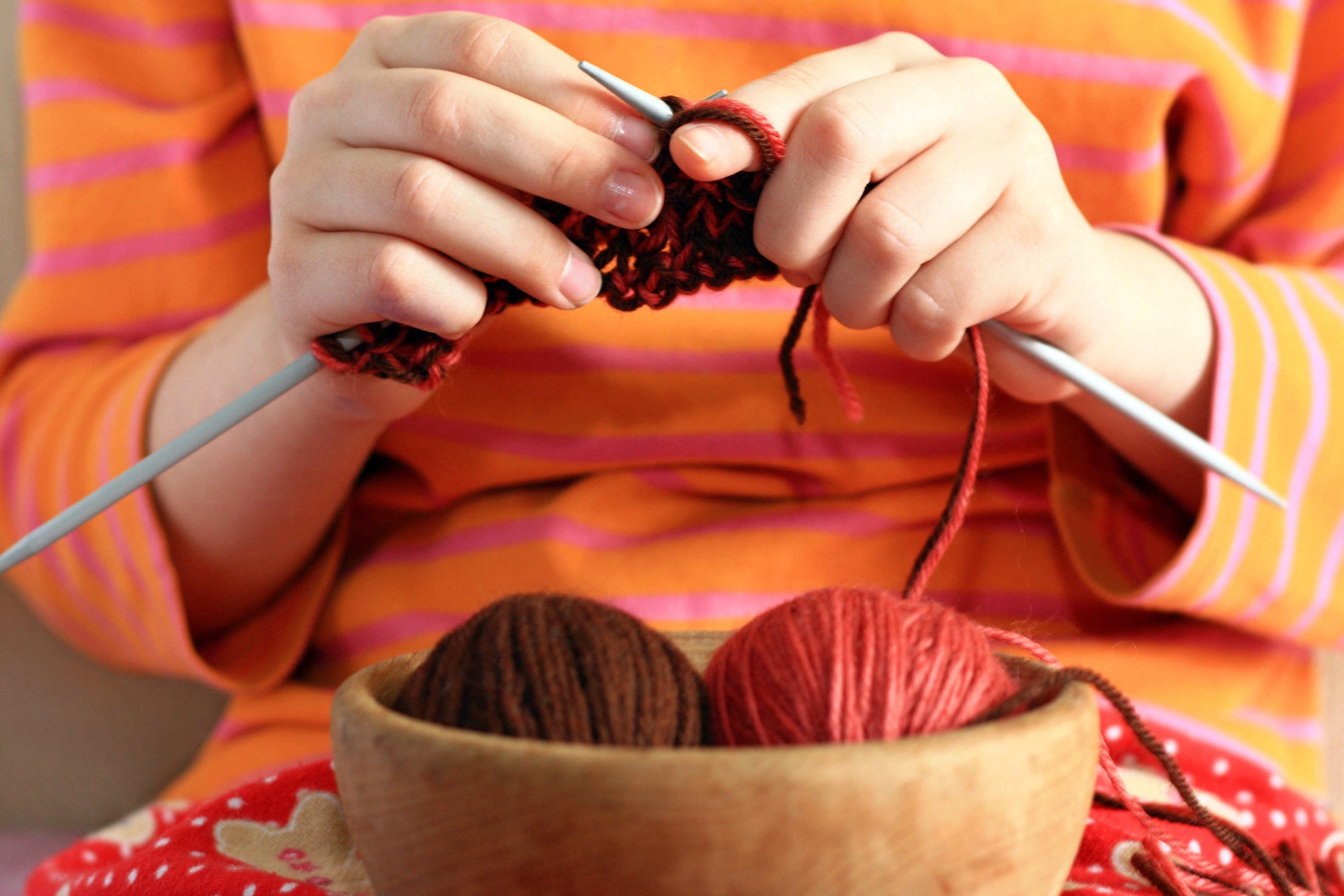 Women knitting with balls of yarn