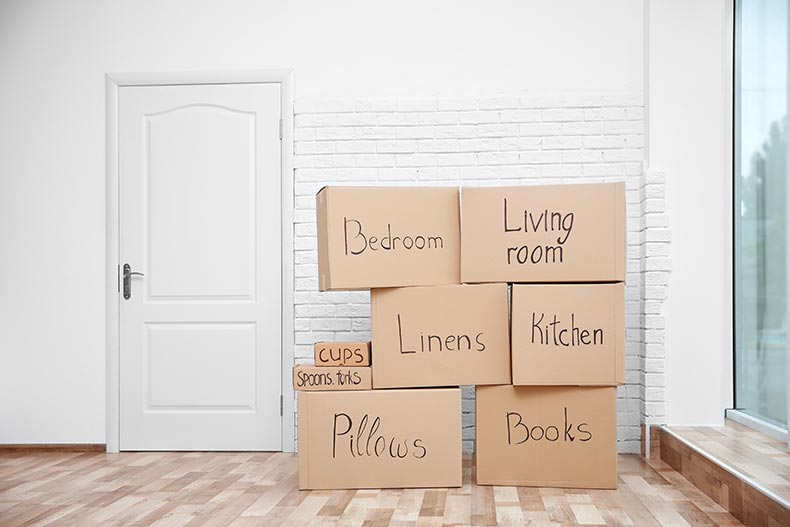 Moving boxes stacked and labeled with black marker